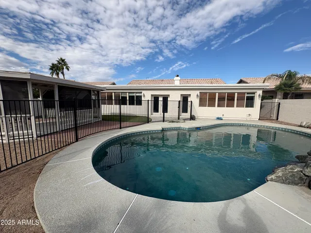 a view of a swimming pool with a yard