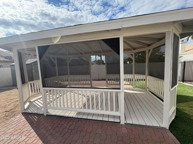 a view of a house with backyard and porch