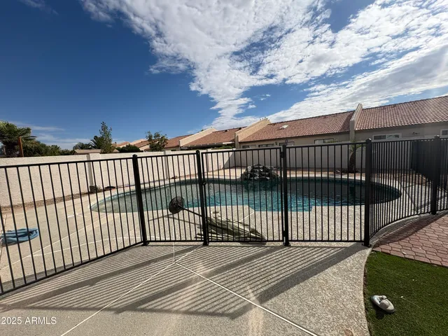 an empty room with closet and a ceiling fan