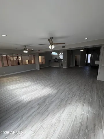a view of a livingroom with furniture wooden floor and windows