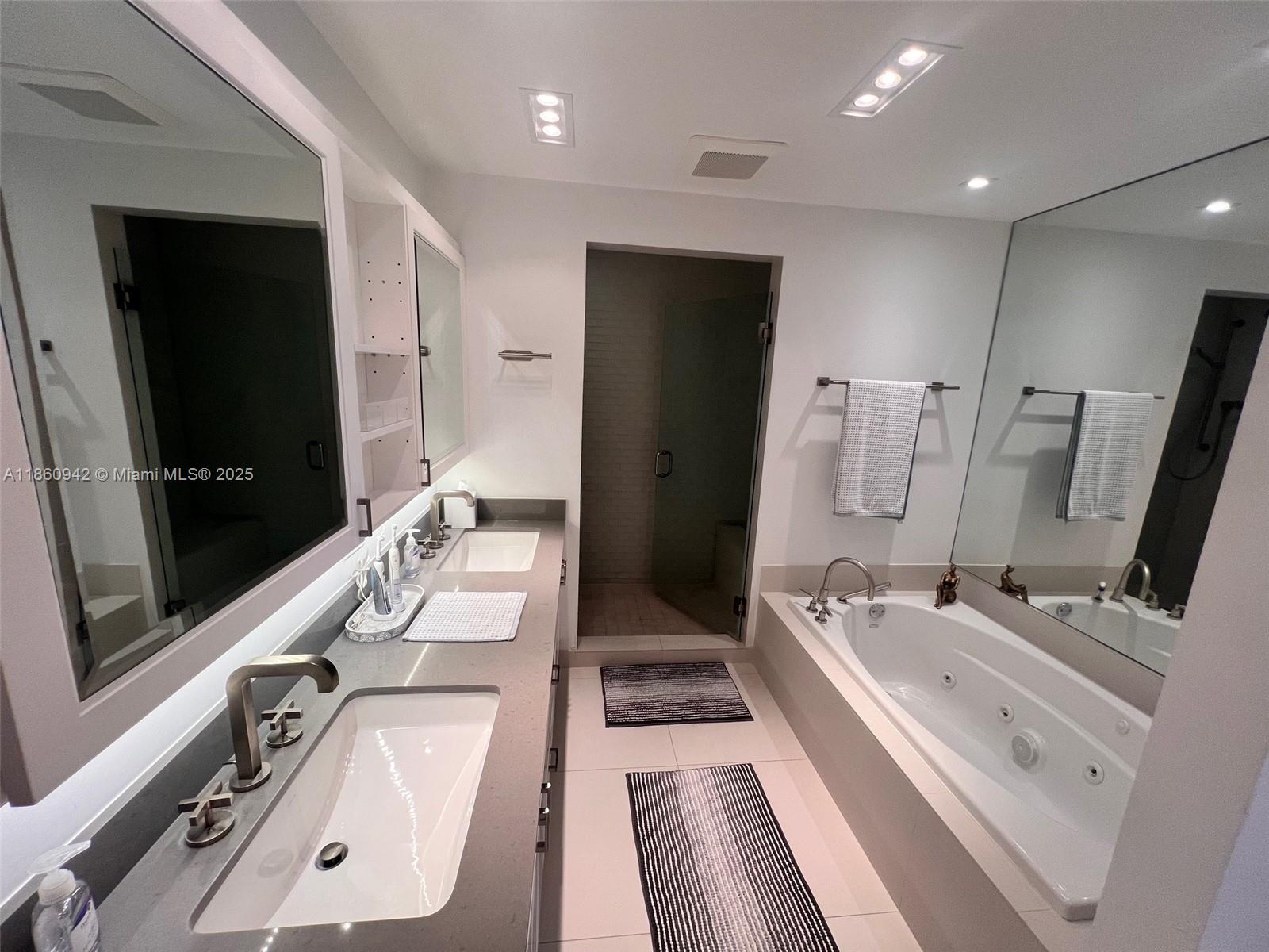 3801 Collins Avenue, Unit 705 Miami Beach, FL 33140 - Photo 10 of 18 a bathroom with a double vanity sink and a mirror