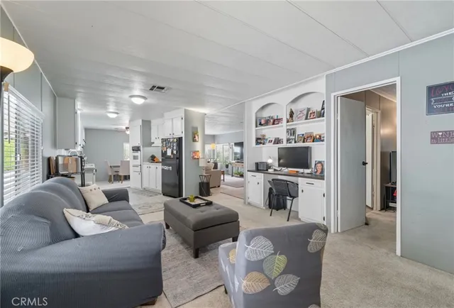 a living room with furniture and kitchen view