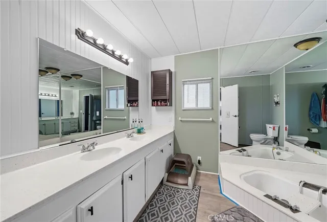 a large bathroom with a double vanity sink mirror and bathtub