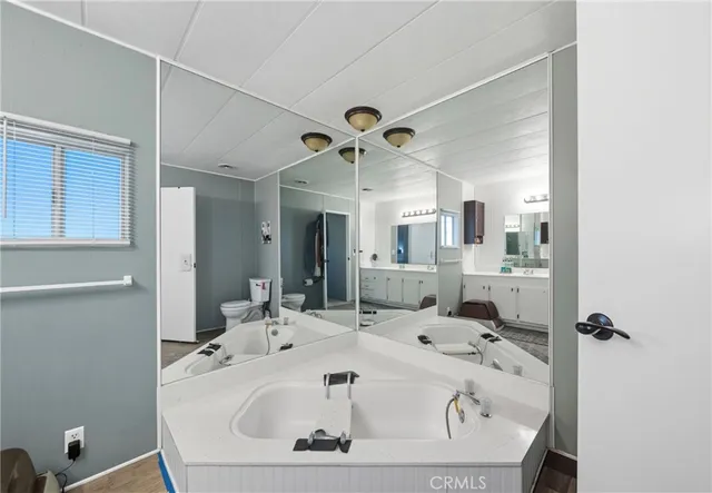 a bathroom with a granite countertop sink mirror and bathtub