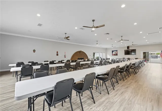 a dinning area with lots of chairs and wooden floor