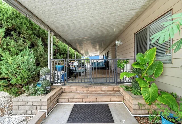 a view of a patio with table and chairs potted plants with wooden floor