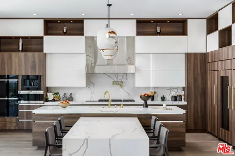 a kitchen with a sink a stove and a refrigerator