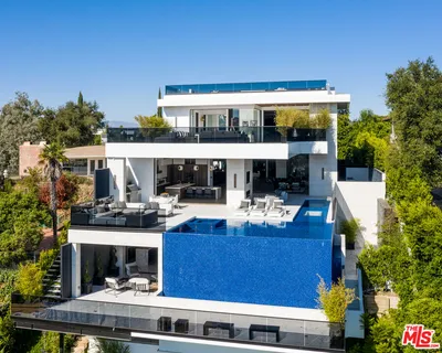 a view of house with swimming pool and sitting area