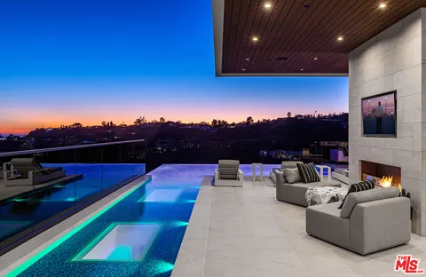 a view of a balcony with couches and city view