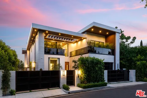 a front view of house with a garden