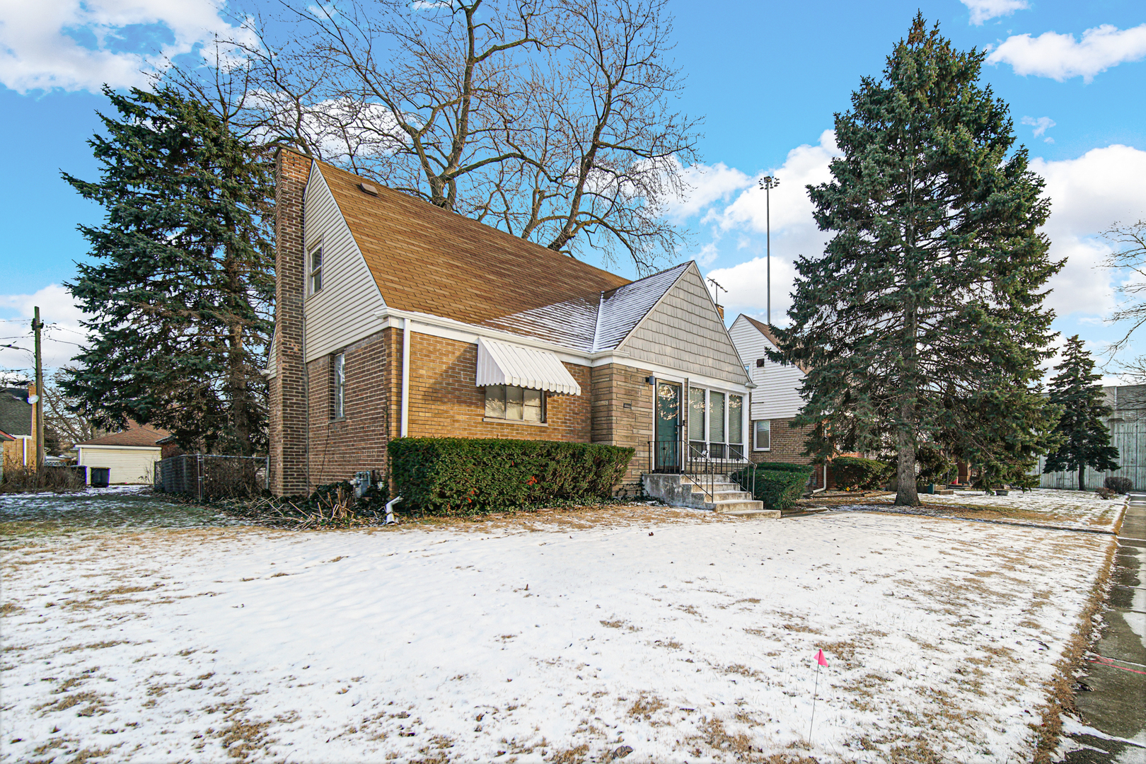 a view of a house with a yard covered in snow