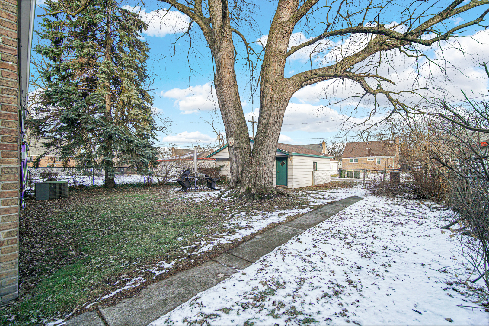 17423 Walter Street Lansing, IL 60438 - Photo 21 of 21 a wooden bench sitting in front of a house