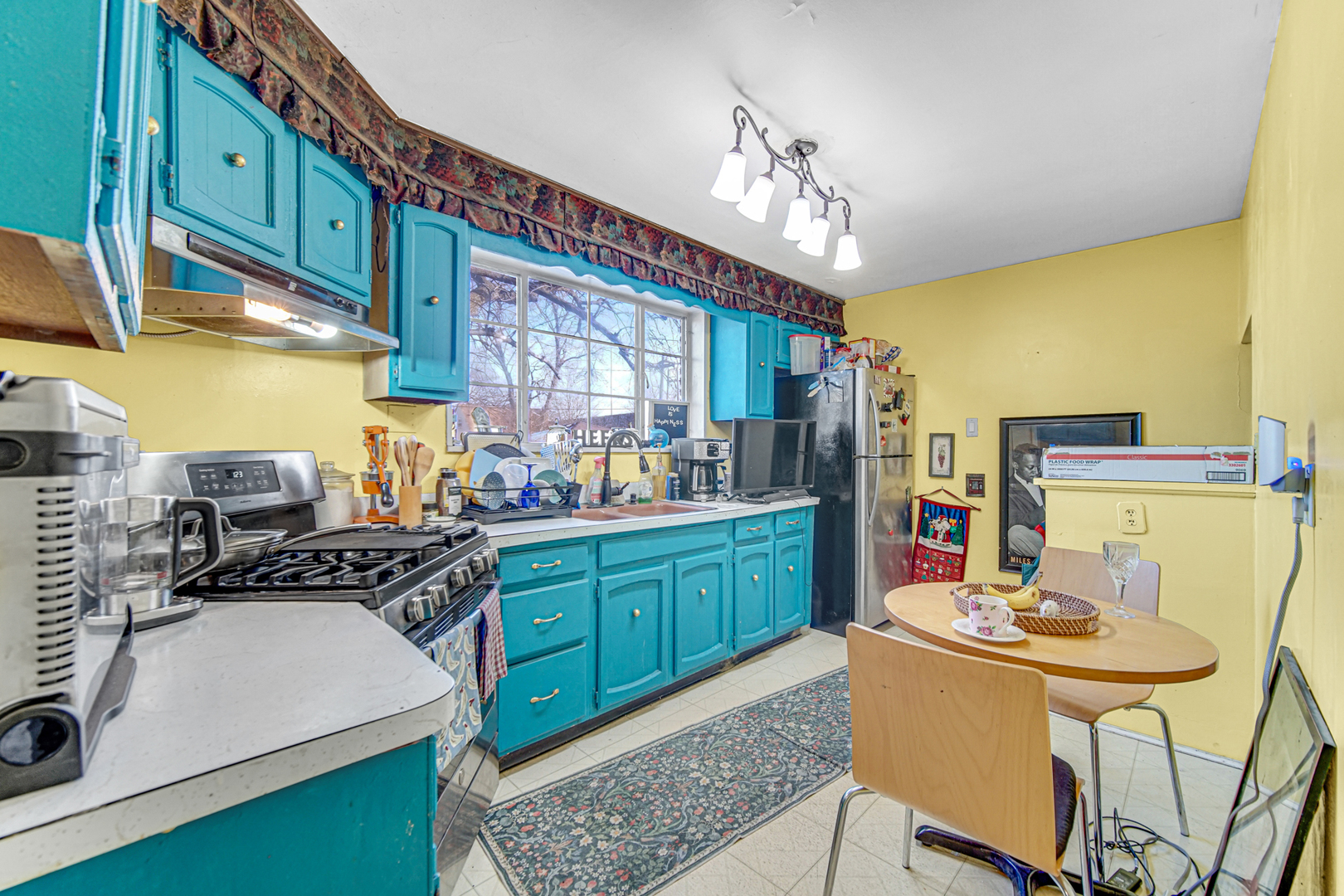 17423 Walter Street Lansing, IL 60438 - Photo 5 of 19 a kitchen with stainless steel appliances granite countertop a sink dishwasher and a refrigerator with wooden floor