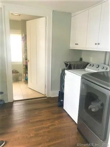a utility room with cabinets washer and dryer