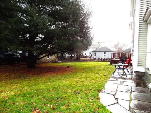 a view of yard with swimming pool and green space