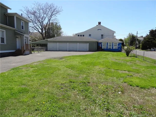 a front view of a house with a garden and plants