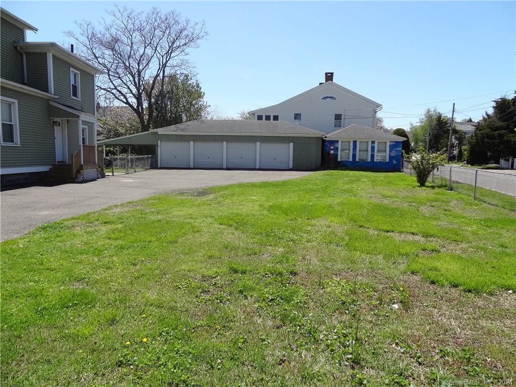 237 Brewster Street Bridgeport, CT 06605 - Photo 22 of 23 a front view of a house with a garden and plants