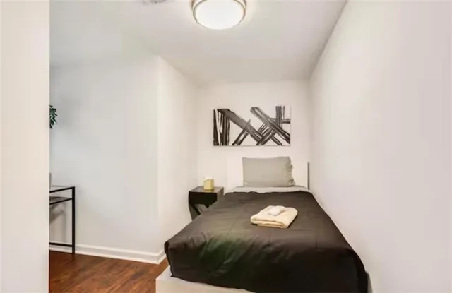 a bedroom with a bed and a couch