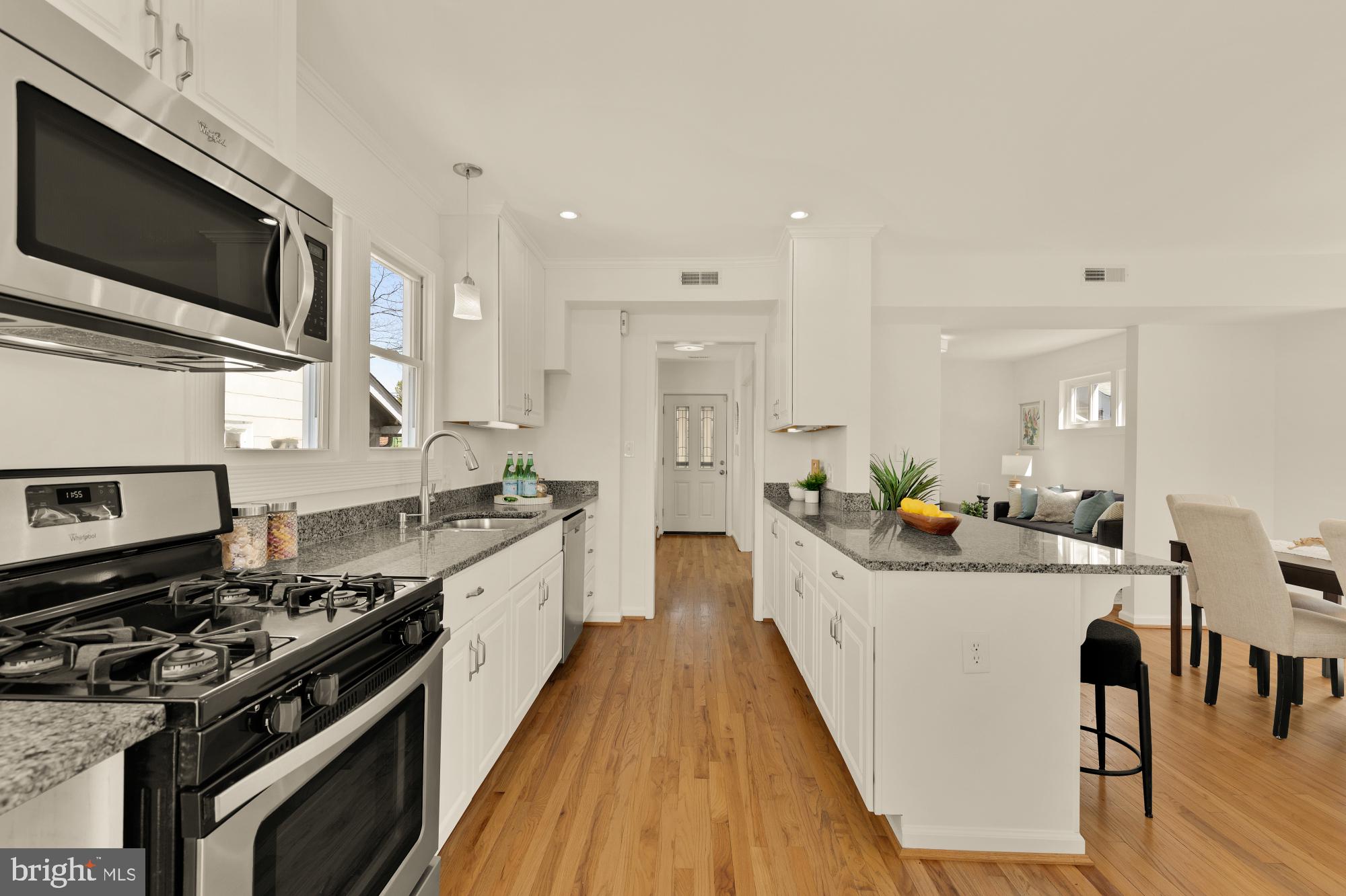 2425 Perry Street Northeast Washington, DC 20018 - Photo 11 of 43 a kitchen with stainless steel appliances a sink stove and wooden floor