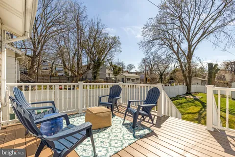 a view of a chairs on deck with wooden floor and fence