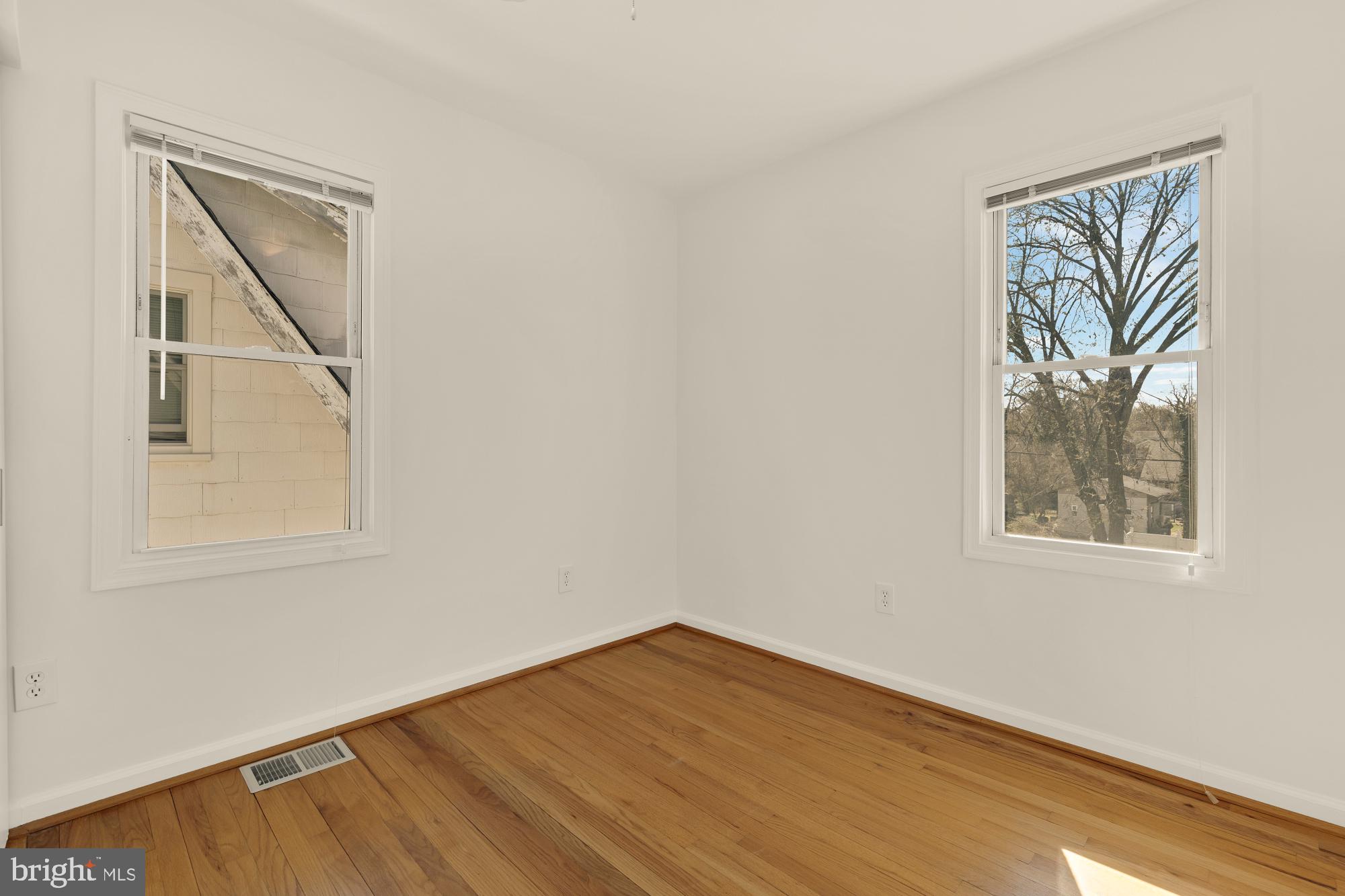 2425 Perry Street Northeast Washington, DC 20018 - Photo 22 of 43 an empty room with a window and wooden floor