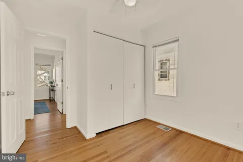 a view of a room with wooden floor and a bathroom