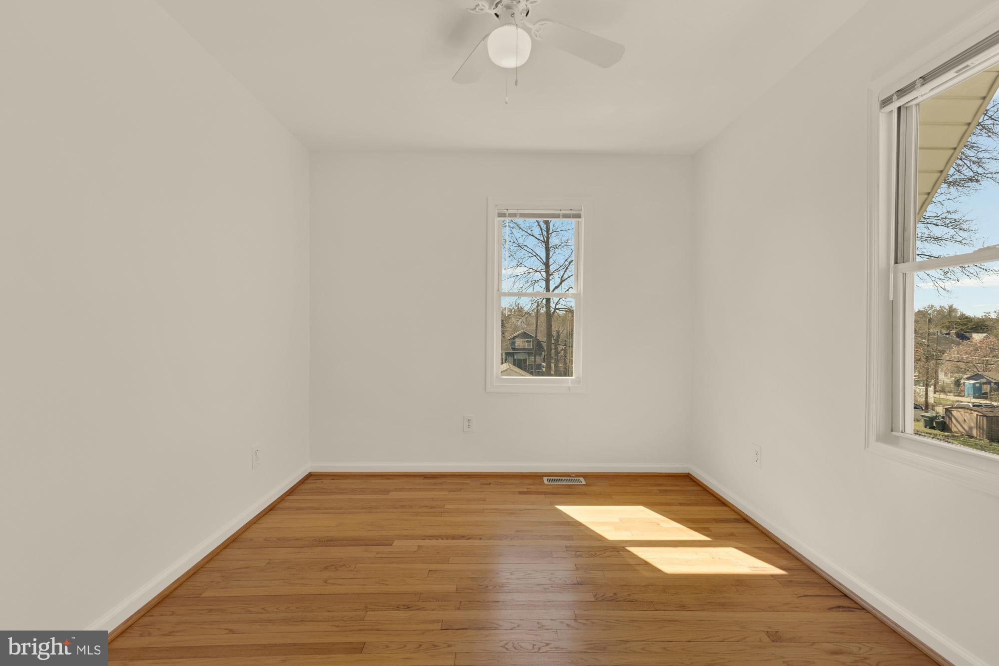 2425 Perry Street Northeast Washington, DC 20018 - Photo 24 of 43 a view of empty room with wooden floor and fan
