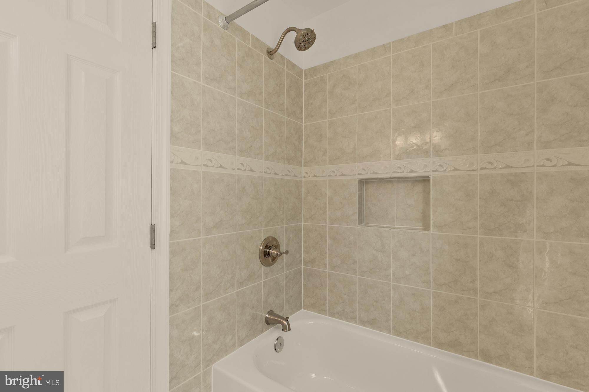 2425 Perry Street Northeast Washington, DC 20018 - Photo 27 of 43 a bathroom with a bathtub and shower