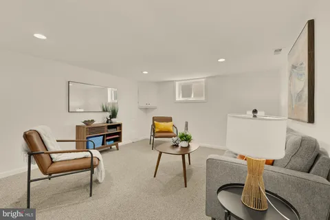 a living room with furniture and a piano