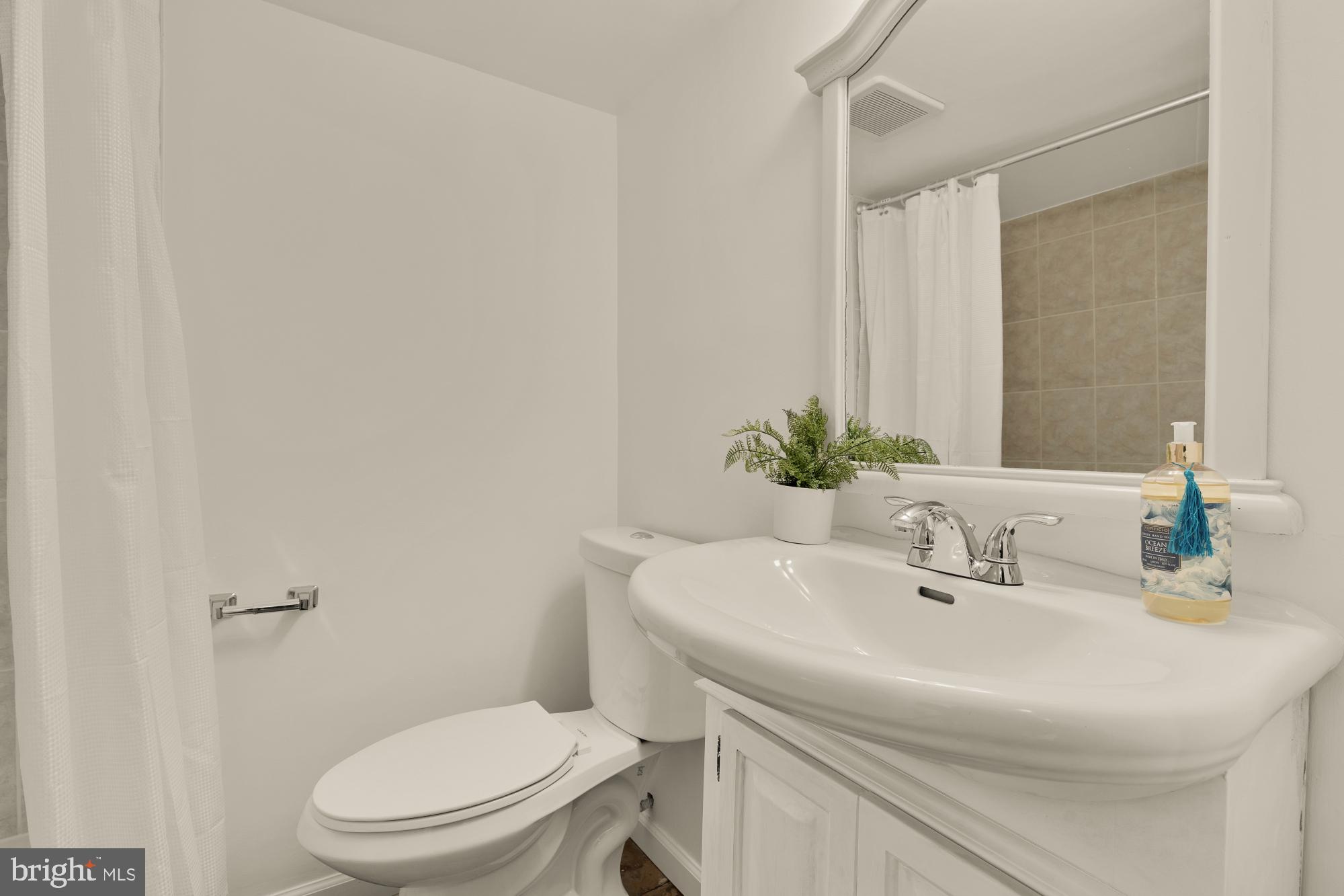 2425 Perry Street Northeast Washington, DC 20018 - Photo 31 of 43 a bathroom with a sink a toilet and a mirror