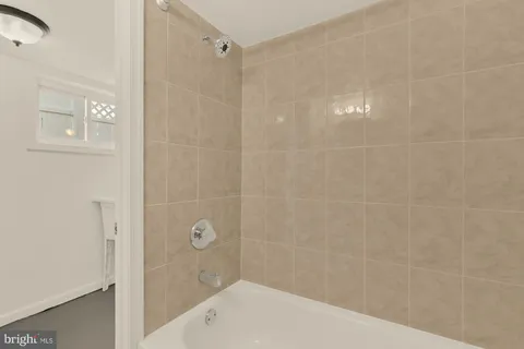 a bathroom with a shower and a glass door