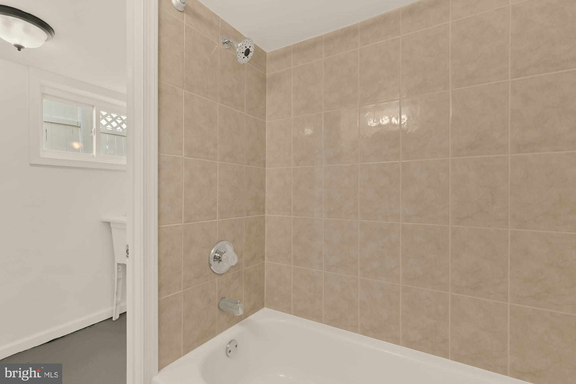 2425 Perry Street Northeast Washington, DC 20018 - Photo 32 of 43 a bathroom with a shower and a glass door