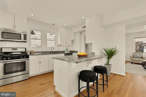 a kitchen with sink cabinets and microwave