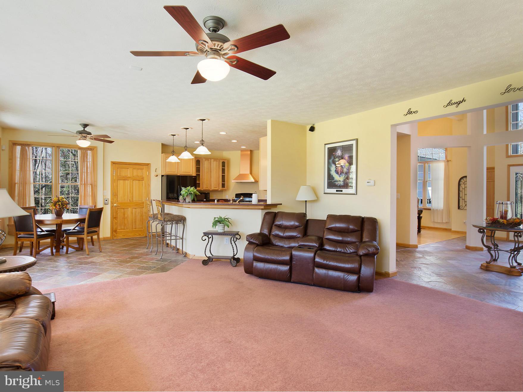 48510 Whitaker Road St. Inigoes, MD 20684 - Photo 11 of 30 a living room with furniture and a dining table with projector the view