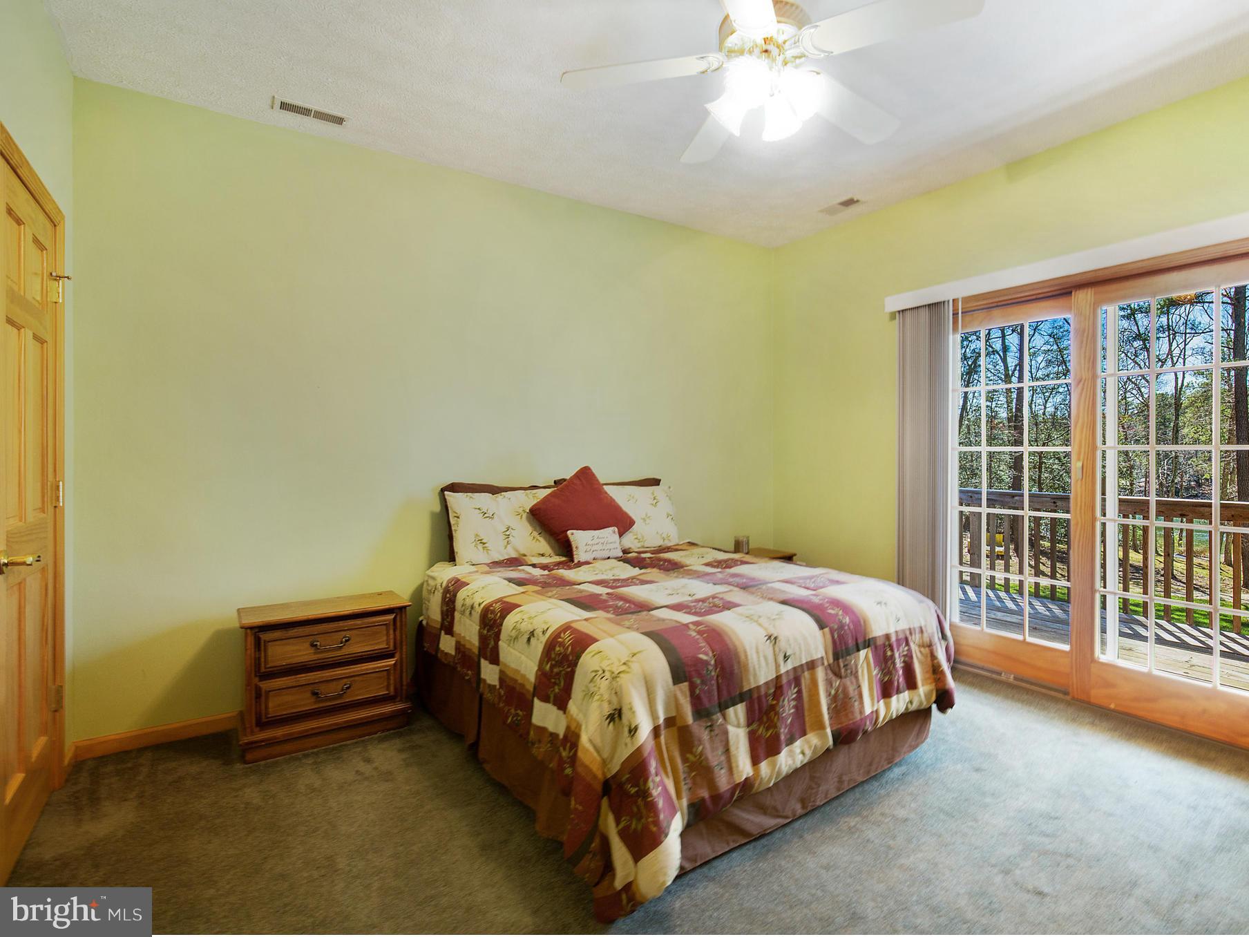 48510 Whitaker Road St. Inigoes, MD 20684 - Photo 18 of 30 a bed sitting in a bedroom next to a window