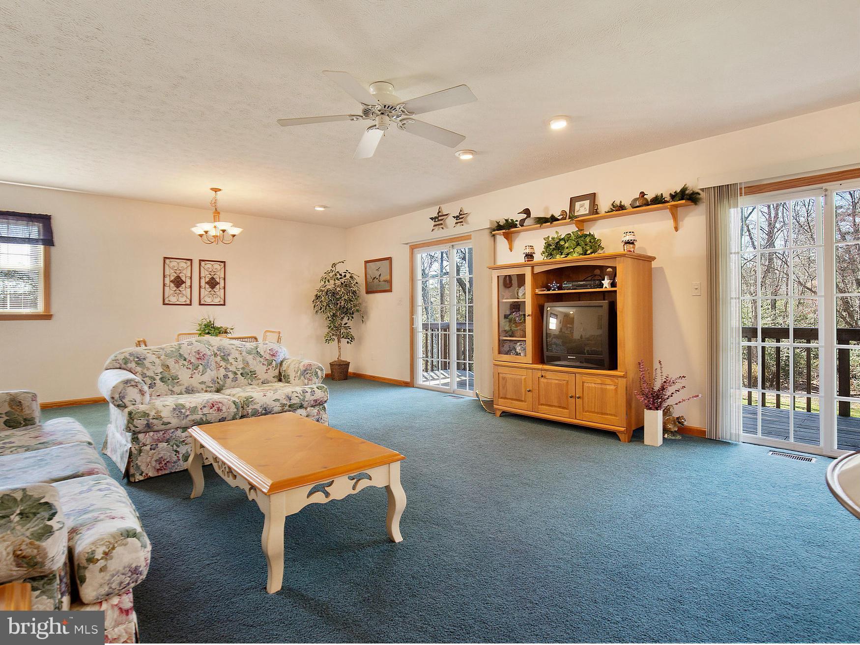 48510 Whitaker Road St. Inigoes, MD 20684 - Photo 23 of 30 a living room with furniture and a flat screen tv