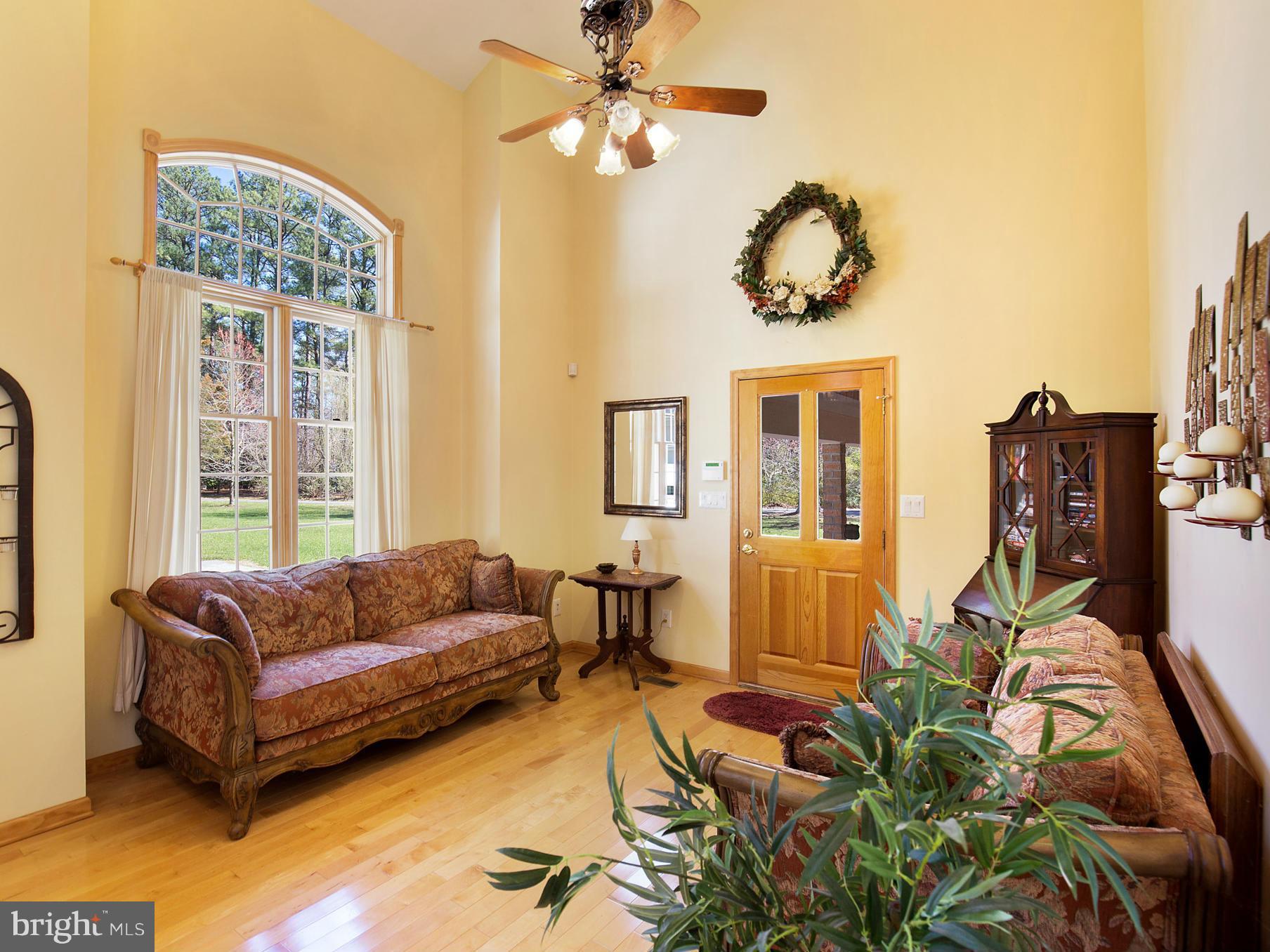 48510 Whitaker Road St. Inigoes, MD 20684 - Photo 6 of 30 a living room with furniture ceiling fan and a window