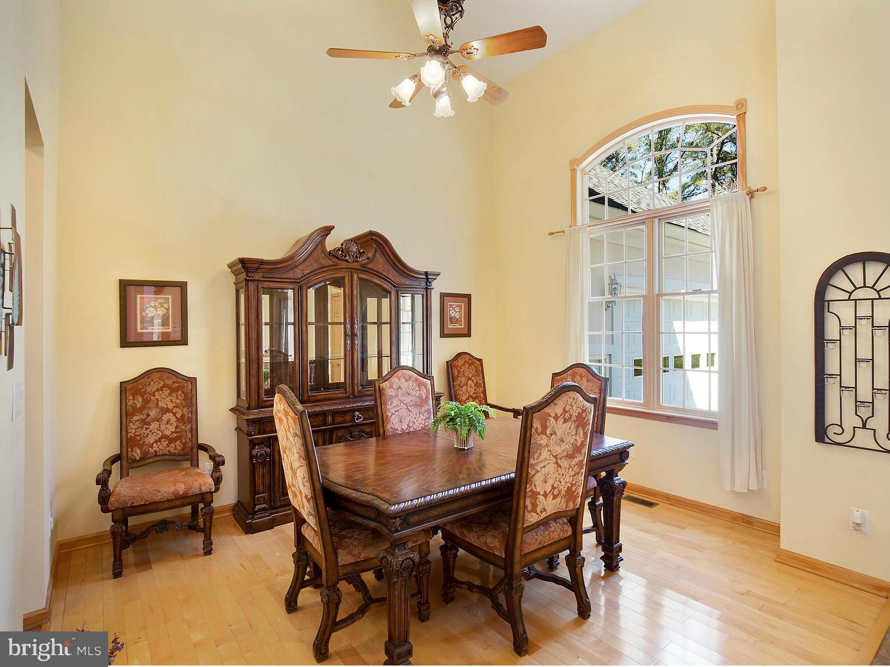 48510 Whitaker Road St. Inigoes, MD 20684 - Photo 8 of 30 a view of a dining room with furniture window and wooden floor