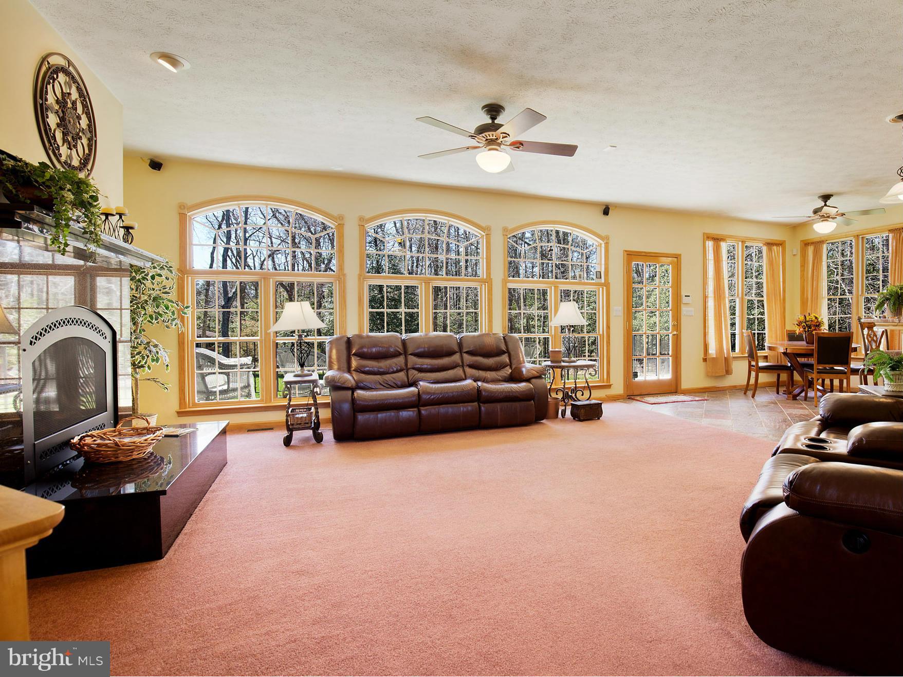 48510 Whitaker Road St. Inigoes, MD 20684 - Photo 10 of 30 a living room with furniture fireplace and a large window