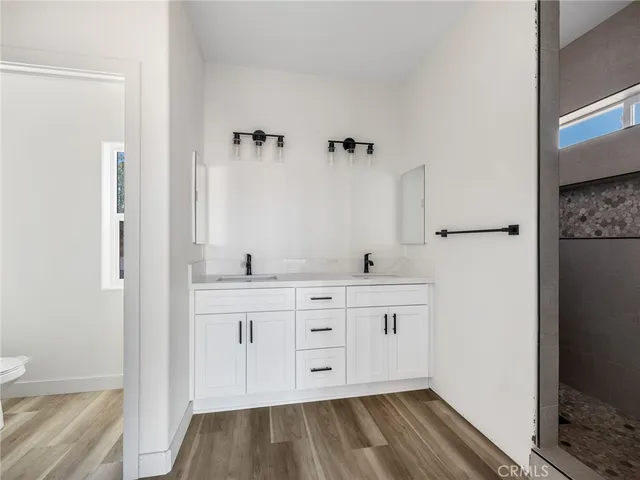 a view of a kitchen with cabinets and wooden floor