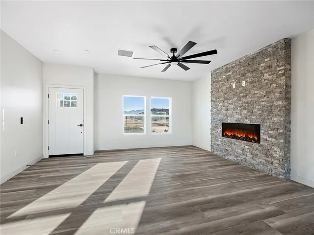a view of an empty room with a fireplace