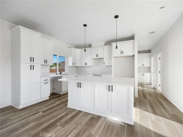 a kitchen with white cabinets and white appliances