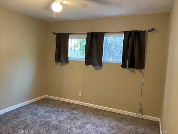 an empty room with windows and closet