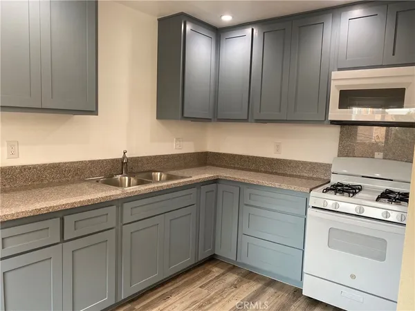 a kitchen with a sink stove and cabinets