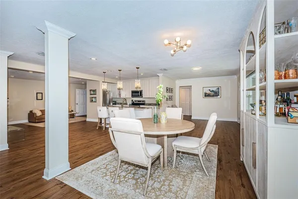 a view of a dining room with furniture and wooden floor
