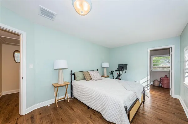 a bed room with a bed and a lamp