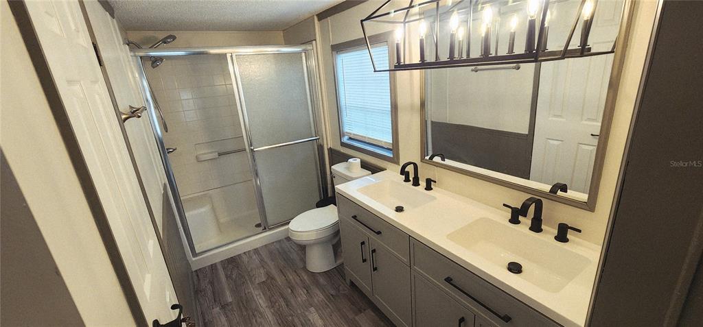 19865 Southwest 5th Place Dunnellon, FL 34431 - Photo 56 of 78 a bathroom with a sink a toilet a mirror and shower