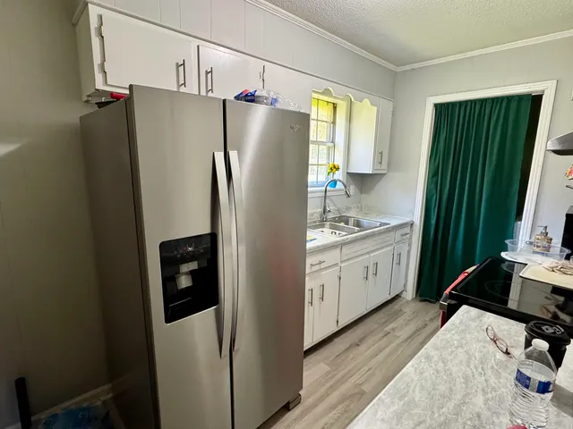 a kitchen with a refrigerator and a sink