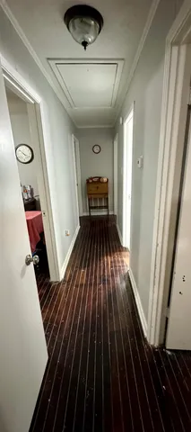 a bedroom with a bed and a lamp on dresser