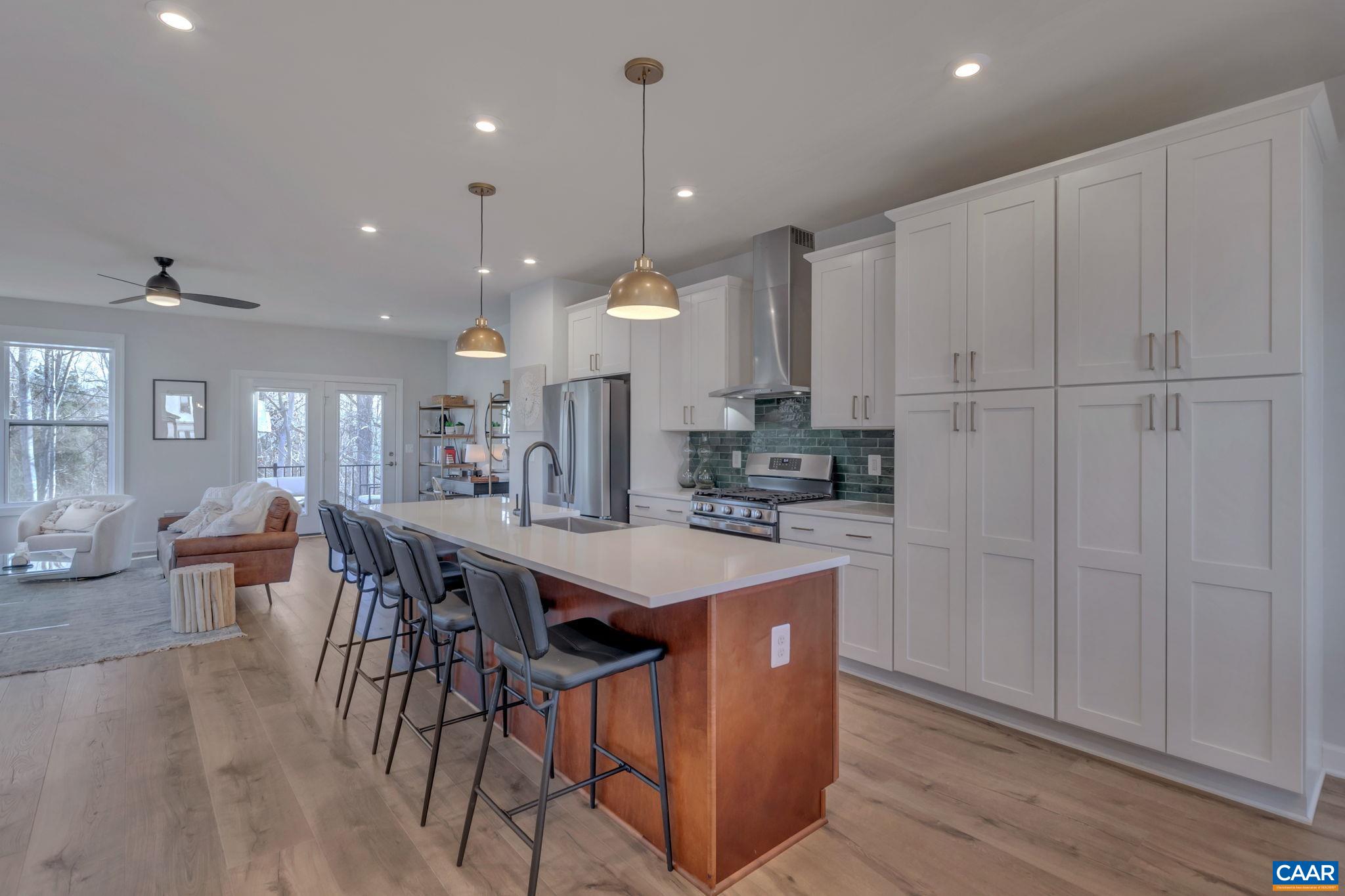 1842 Fowler Street Charlottesville, VA 22901 - Photo 14 of 44 a large kitchen with kitchen island a sink table and chairs